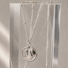 Necklace with a pendant on an acrylic stand against a neutral background
