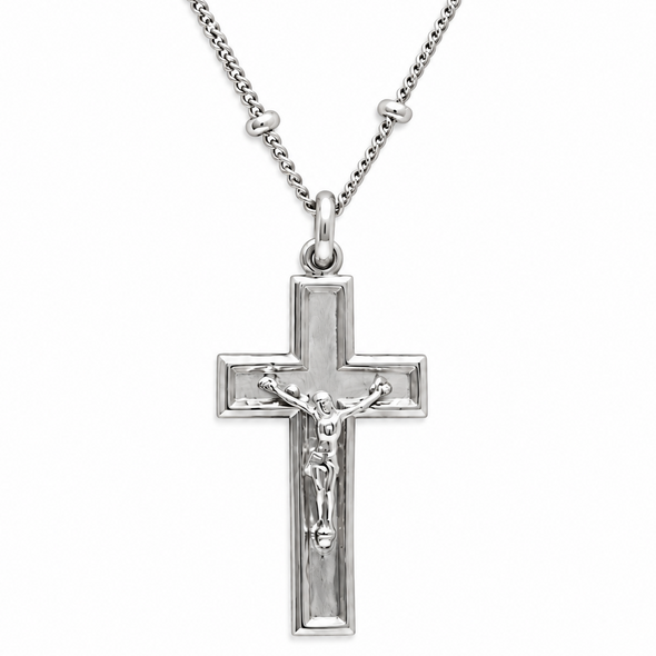 Silver crucifix pendant necklace with a detailed corpus on a polished cross, suspended from a matching chain on a white background.