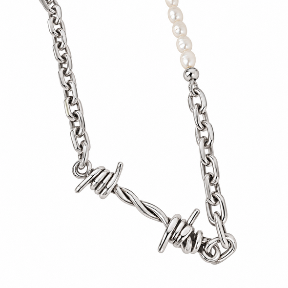 A silver-toned chain necklace featuring a twisted barbed wire pendant and a section of white pearl beads, shown against a plain white background.