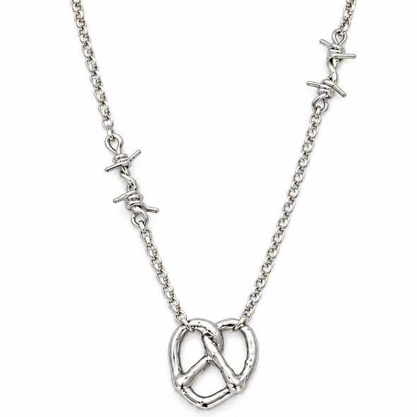 A silver chain necklace featuring a central pretzel pendant and two small barbed wire charms on either side of the chain, shown against a plain white background.