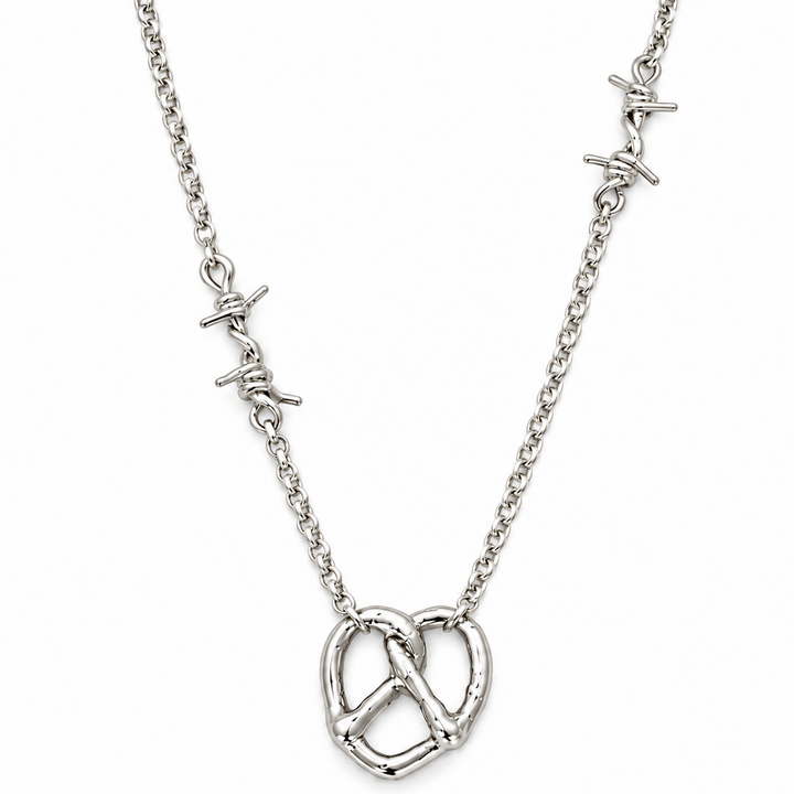 A silver chain necklace featuring a central pretzel pendant and two small barbed wire charms on either side of the chain, shown against a plain white background.