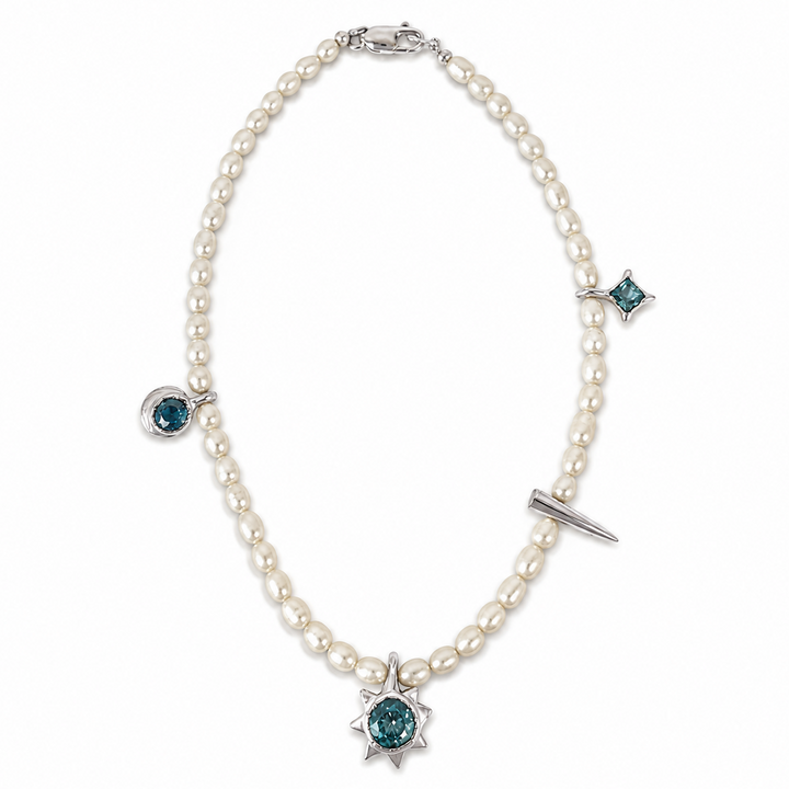 A pearl necklace with silver-toned metal settings and blue-green gemstone accents, including a prominent sunburst pendant at the center and smaller star and oval motifs at other points.
