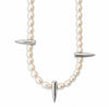 A pearl necklace with silver-toned spike accents, featuring a curved line of white pearls and three pointed metallic spikes, shown against a plain white background.