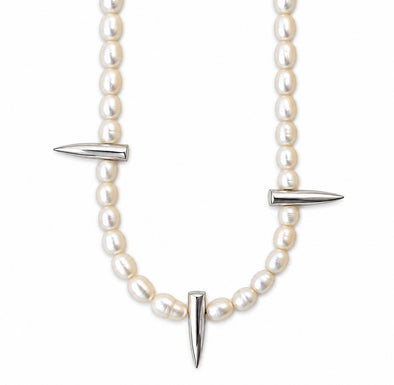 A pearl necklace with silver-toned spike accents, featuring a curved line of white pearls and three pointed metallic spikes, shown against a plain white background.