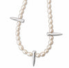 A pearl beaded necklace with three polished silver-toned spike accents, displayed on a clean white background.