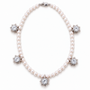 A pearl necklace with five star-shaped settings, each holding a clear round gemstone, displayed on a clean white background.