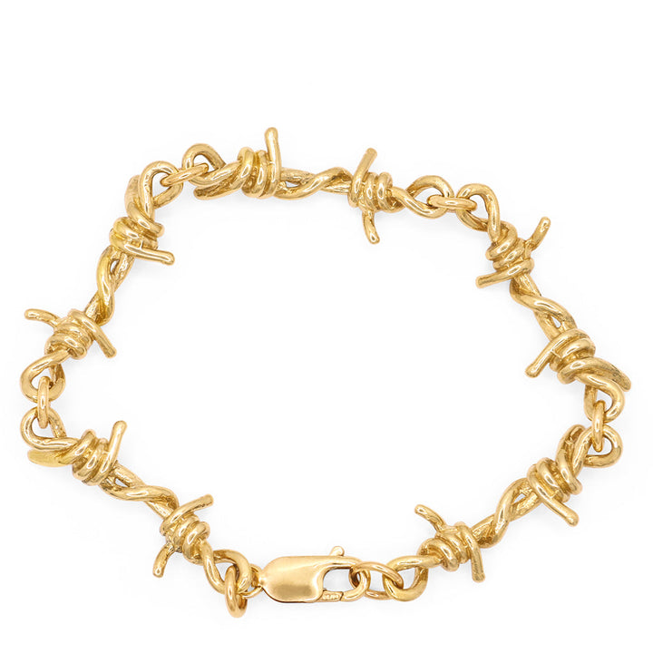 A gold barbed wire link bracelet with a lobster clasp closure.