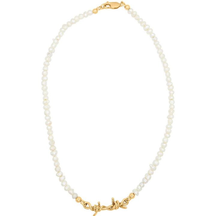 A white pearl necklace with a gold barbed wire link chain.