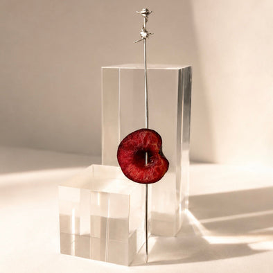 A sterling silver cocktail pick with barbed wire detail, handmade by Britt Bolton