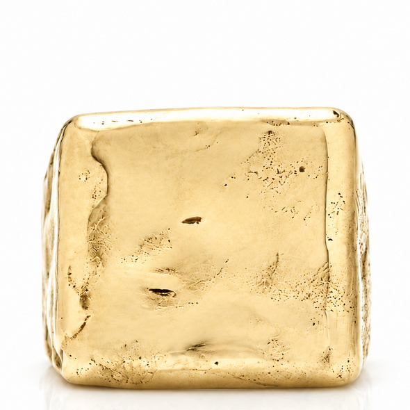 A square gold ring with a heavily textured, organic, hammered surface, photographed on a clean white background with a soft reflection below.