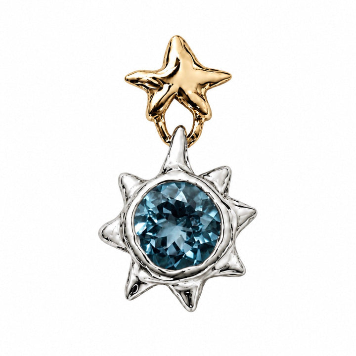 A two-tone celestial pendant featuring a polished gold star at the top and a textured silver sunburst frame around a round faceted blue gemstone, set against a plain white background.