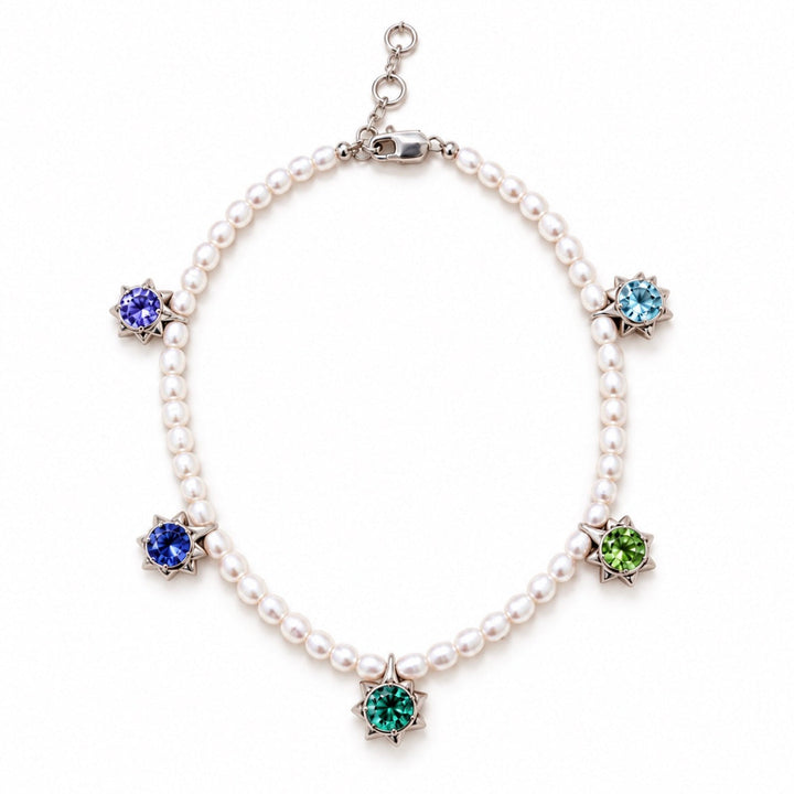 A pearl necklace with silver-toned settings and five colorful gemstone flower-shaped charms in blue, green, and light blue, displayed on a clean white background.