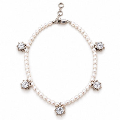 A pearl necklace with five star-shaped diamond clusters set in silver-toned metal, displayed on a clean white background.
