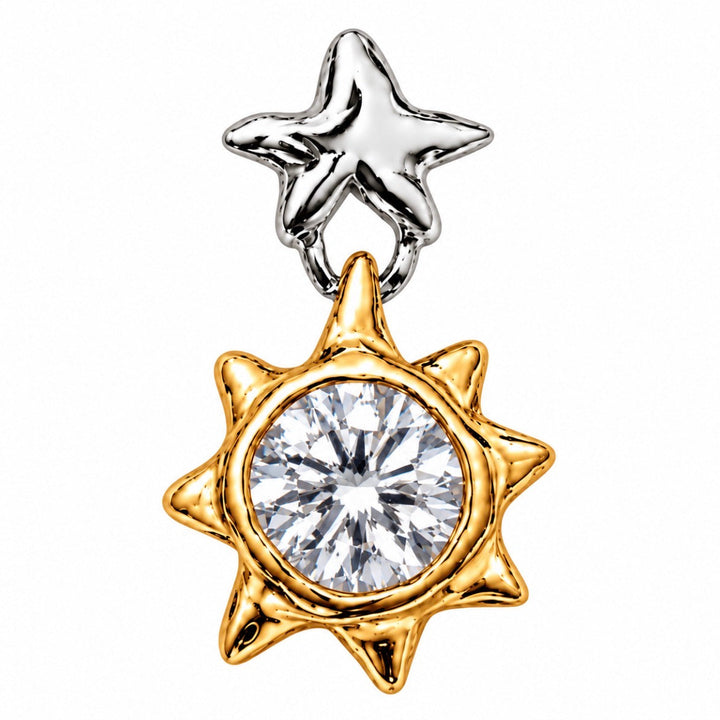 A two-tone celestial charm featuring a polished silver star at the top and a gold sunburst at the bottom, with a large round clear gemstone in the center, set against a plain white background.
