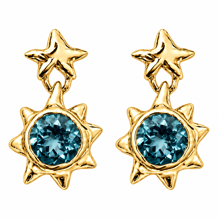 A pair of gold starburst dangle earrings with round blue gemstones, shown on a plain white background.
