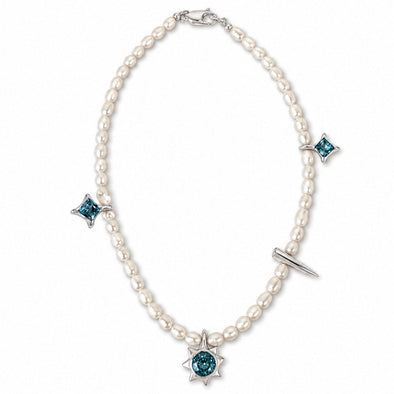A pearl necklace with a silver-tone starburst pendant featuring a round teal gemstone, accented with three matching starburst charms and a small silver bar detail, shown on a plain white background.