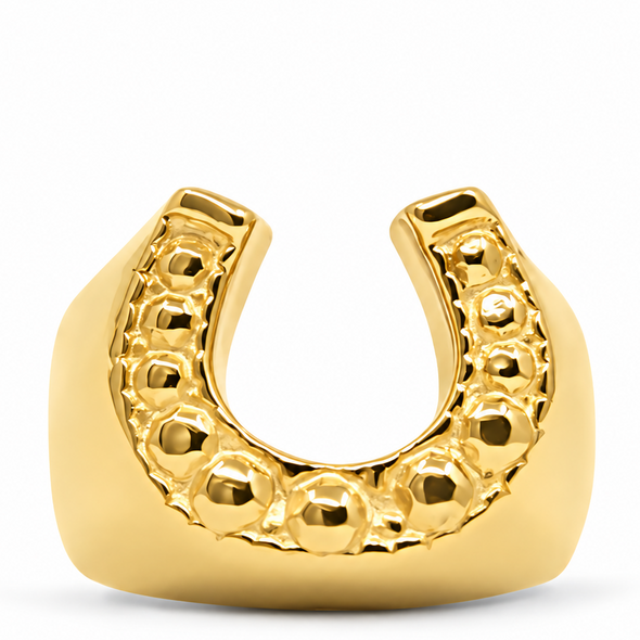 A gold horseshoe-shaped mouthguard with a textured beaded inner curve, shown on a clean white background.