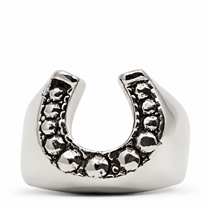A silver horseshoe-shaped ring with a textured, dark oxidized pattern along the top curve, set against a plain white background.