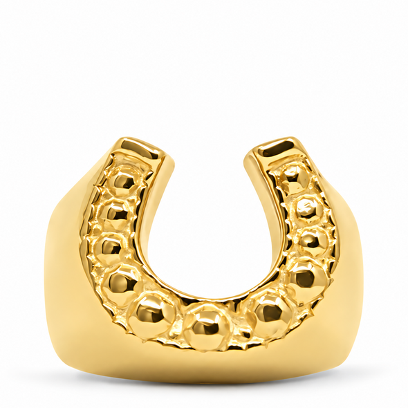 A gold horseshoe-shaped mouthguard with a textured beaded inner curve, shown on a clean white background.