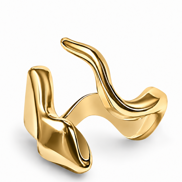 A sculptural abstract gold ring with a polished, fluid, wavy design, shown on a clean white background.