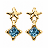 A pair of gold star-shaped drop earrings with a faceted light blue gemstone at the bottom, shown on a plain white background.