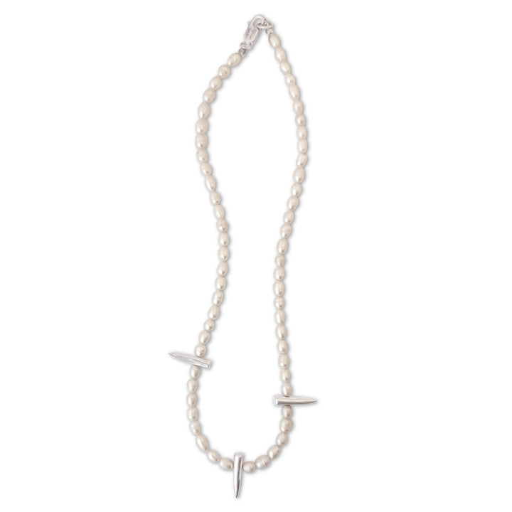Pearl necklace with silver pendants on a white background