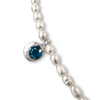 Pearl necklace with a blue gemstone pendant on a white background