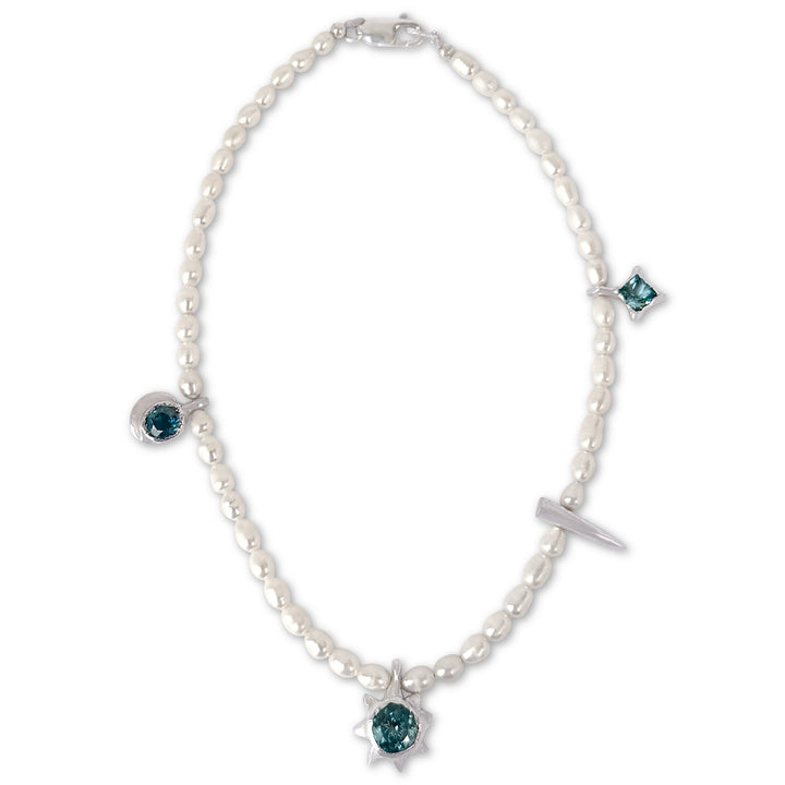 Pearl necklace with blue gemstones on a white background