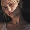 Close-up of a person with a necklace against a dark background