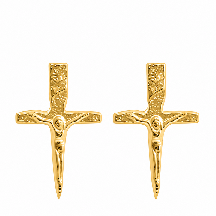 A pair of gold crucifix stud earrings with a textured, embossed design, shown on a plain white background.