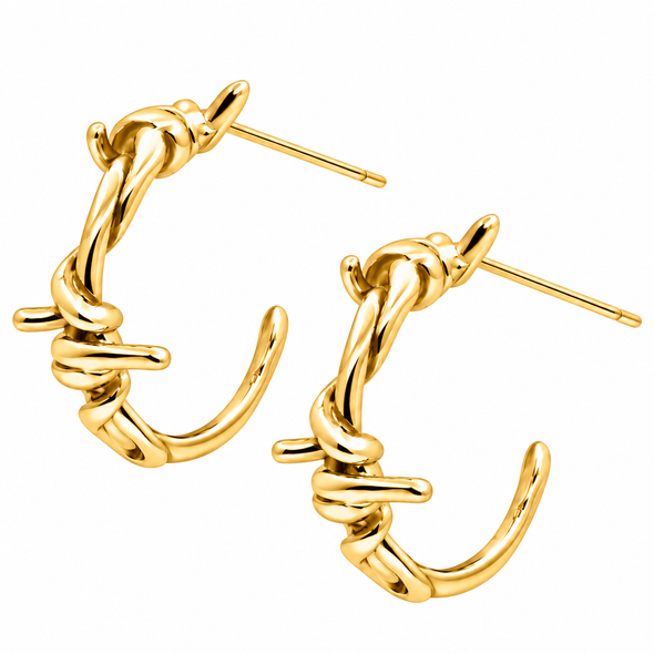 A pair of gold huggie hoop earrings with a twisted, barbed wire-inspired design, shown on a plain white background.