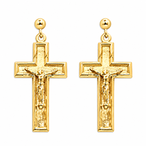 A pair of gold crucifix earrings with a textured cross design featuring a detailed figure of Jesus on the front, suspended from round gold studs on a plain white background.