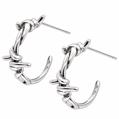 A pair of polished silver hoop earrings with a twisted, barbed-wire-inspired design and straight post backings, shown on a plain white background.