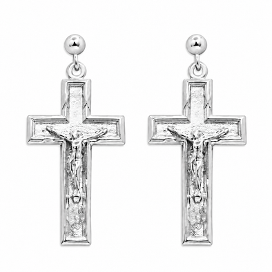 A pair of silver crucifix dangle earrings with textured cross pendants, featuring a detailed corpus and a small round ball stud at the top, shown against a plain white background.
