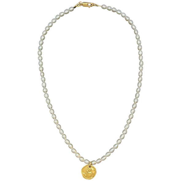 Pearl necklace with a gold pendant on a white background