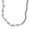A silver-toned metal chain necklace featuring multiple barbed wire motifs along the front, shown against a plain white background.