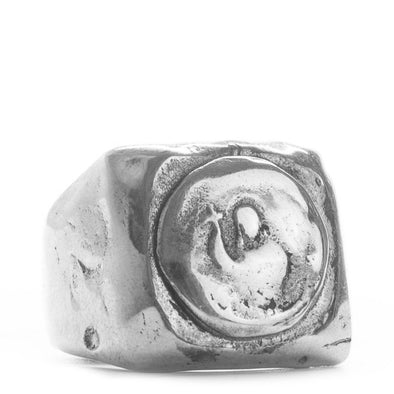 Silver ring with a textured design on a white background