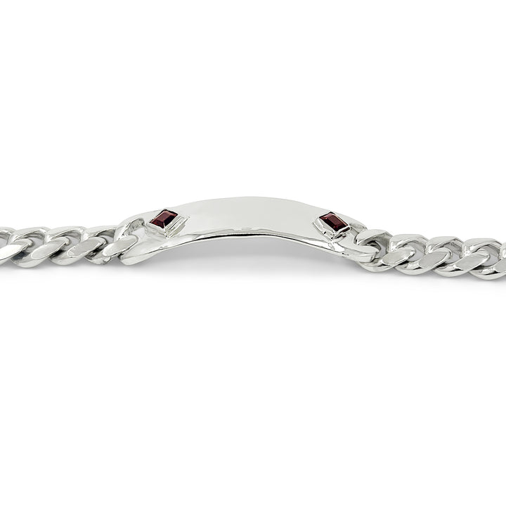 Silver chain bracelet with red gemstones on a white background