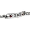 Silver bracelet with engraved initials and red stones on a white background