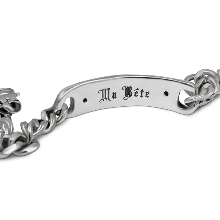 Silver chain bracelet with engraved text on a white background