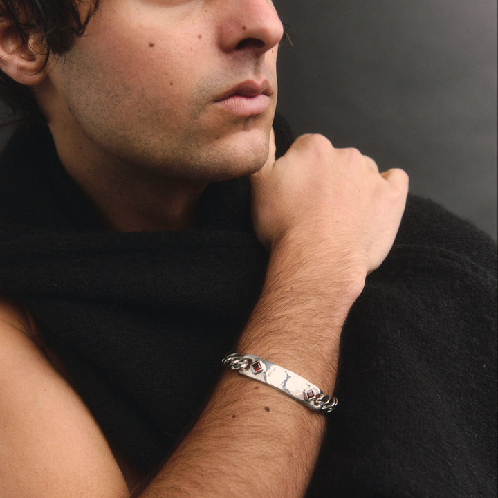 Man wearing a black sleeveless top with a blurred background