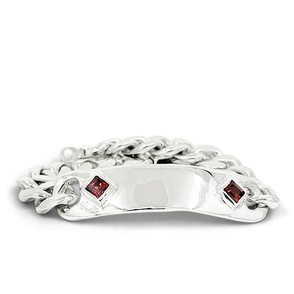 Silver bracelet with red gemstones on a white background