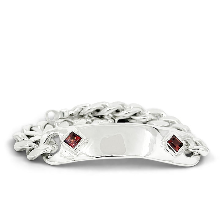 Silver bracelet with red gemstones on a white background