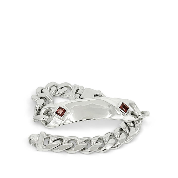 Silver chain bracelet with red stones on a white background