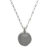 Silver necklace with a round pendant on a white background