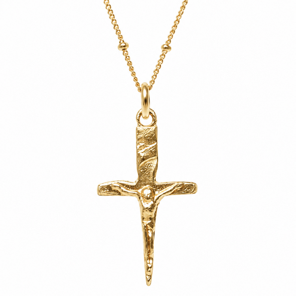 A textured gold crucifix pendant necklace on a delicate gold chain, shown against a plain white background.