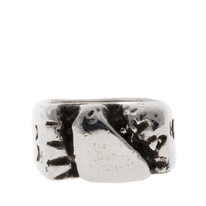 Silver ring with a textured design on a white background