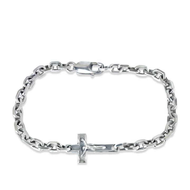 Silver chain bracelet with a cross charm on a white background