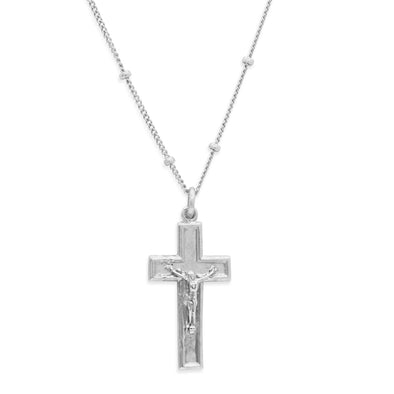 Silver crucifix pendant on a chain against a white background