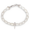 Pearl bracelet with a silver spike charm on a white background